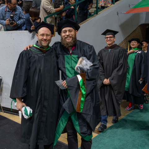 Commencement 2024, two people in academic regalia