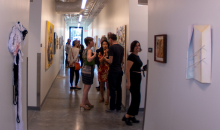 Guests enjoying graduate student work on display in the art annex.