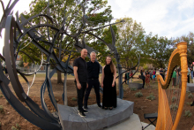 Shadow Garden artist Matthew Ritchie standing on the sculpture with countertenor Daniel Bubeck and harpist Ruth Mertens after their performance.