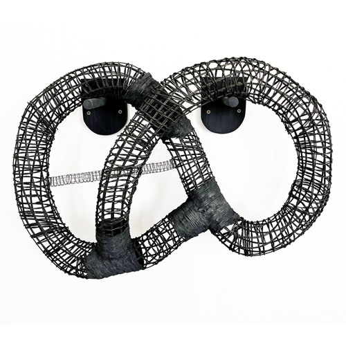 Bound, a woven black sculpture in a continuous twisted loop