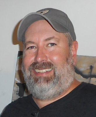 Derrick White smiling, wearing a gray baseball cap